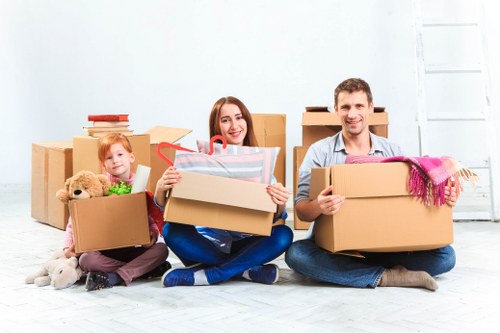 Professional movers carrying items through a Fitzrovia apartment building staircase