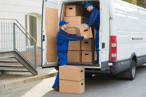Removal crew carrying items through a narrow Fitzrovia staircase