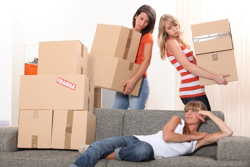 Local moving team handling boxes in a Fitzrovia property